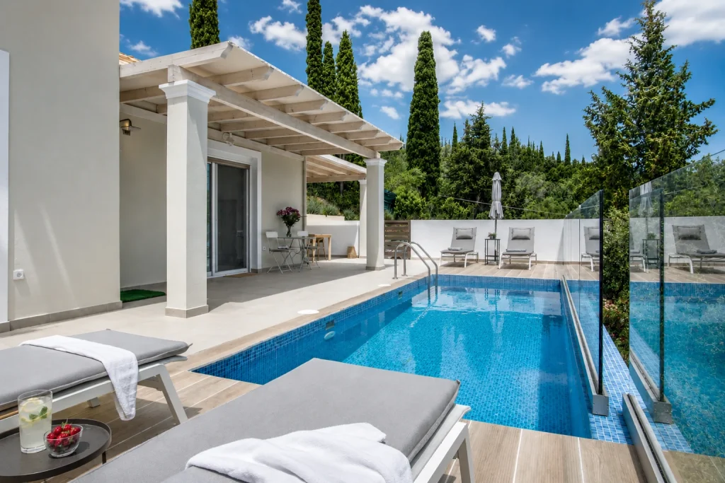 giardinia corfu holiday homes pool deck dining loungers